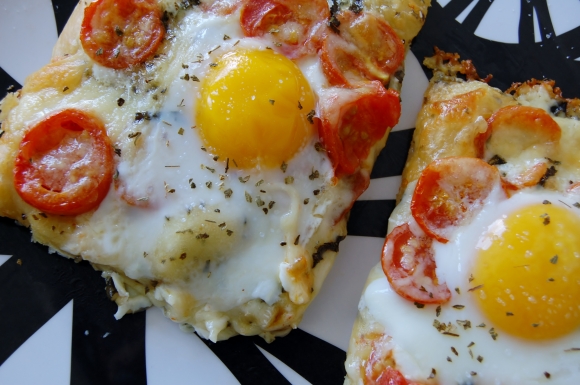 breakfast pizza with cherry tomatoes and white cheddar